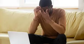 Person On Sofa Working From Home Suffering Stress Listing Page